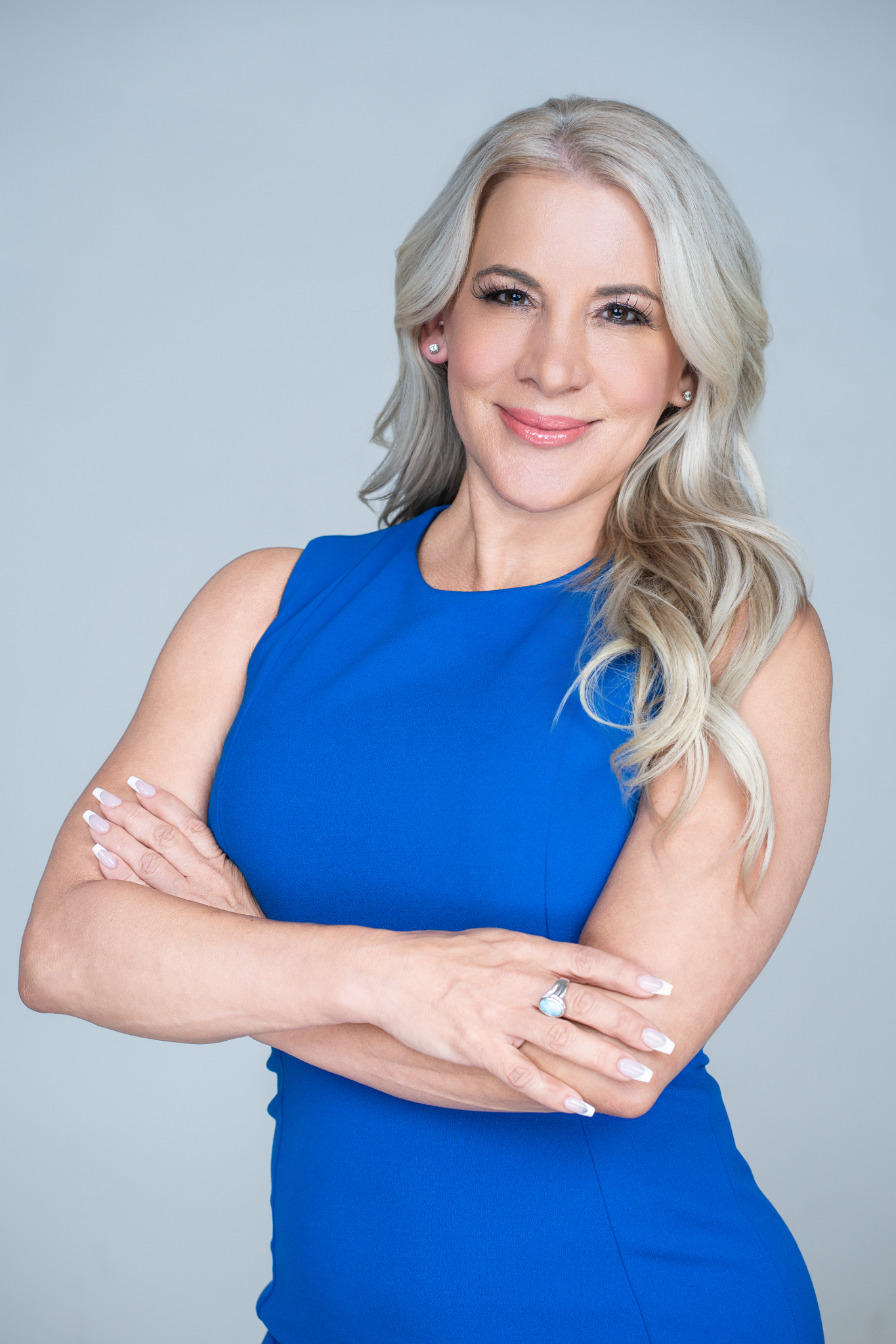Dr. Julie Wilkes in a blue outfit with her arms folded
