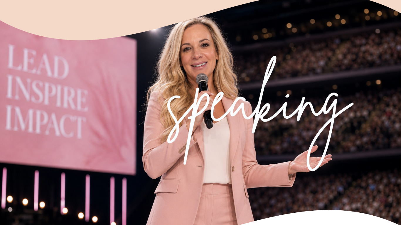 Julie speaking on stage with a microphone